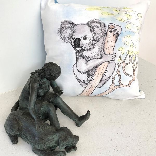 Kala the Koala printed on cushion cover. Pictured with bronze sculpture 'Phone Support' also by Lucinda Brash