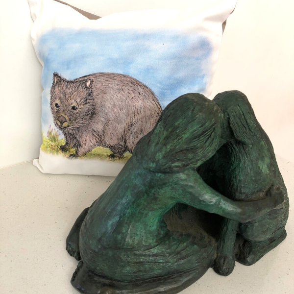Hatty the Wombat on cushion cover pictured with 'Meeting of Minds' bronze sculpture also by Lucinda Brash