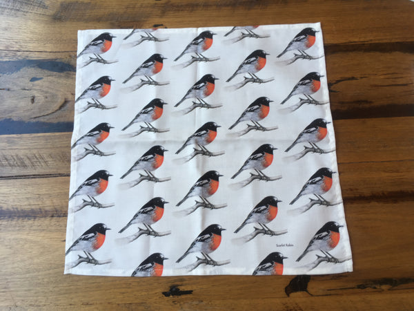 Single cloth napkin or serviette with a repeating patter of the male Scarlet Robin